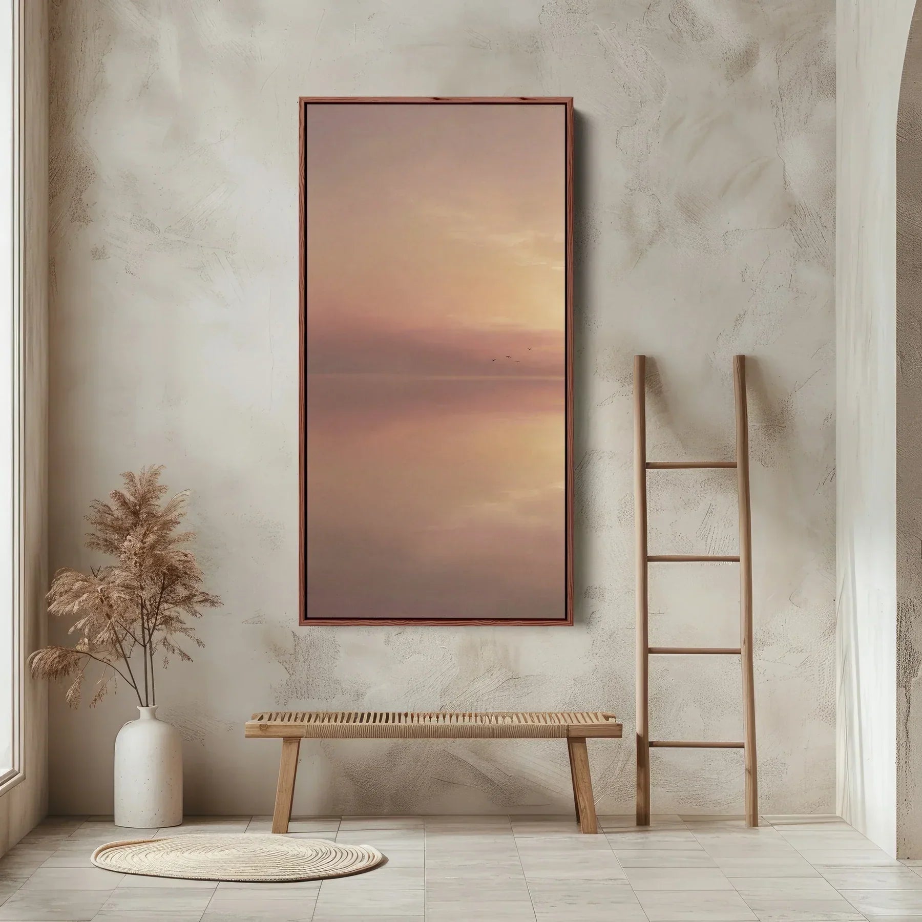 Framed narrow vertical sunset landscape wall art featuring a calm lake and warm golden tones, styled in a modern minimalist entryway.