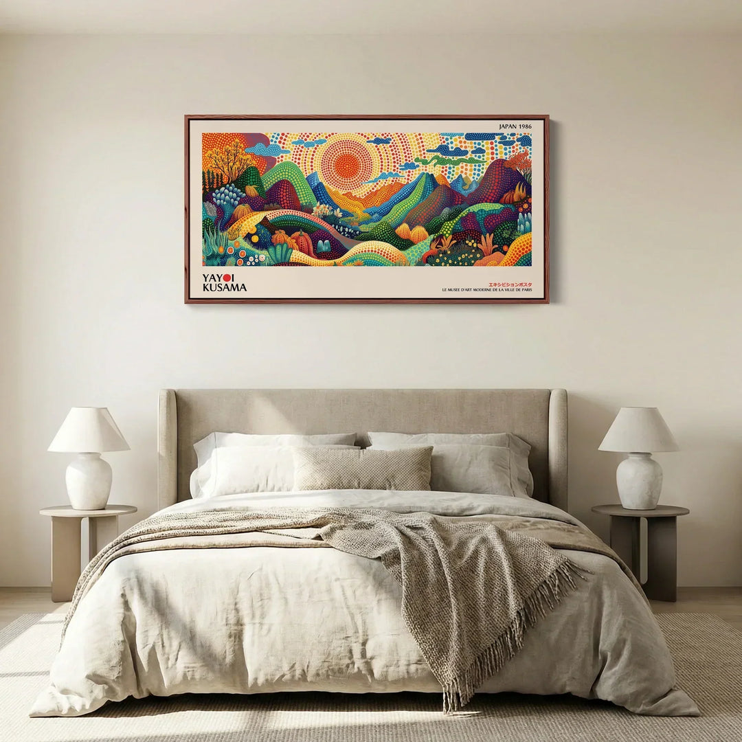 Framed Japanese landscape art print with colourful hills and a bright sun, styled above a bed in a contemporary minimalist bedroom.