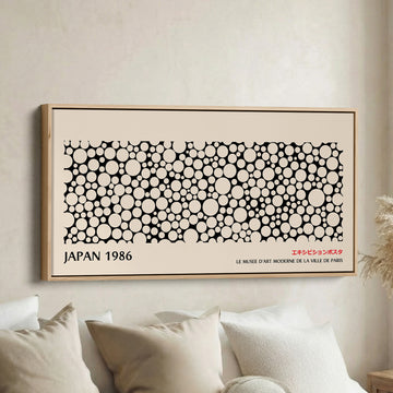 Japanese wall art black and white dot pattern horizontal canvas print in a wood floating frame displayed in a living room