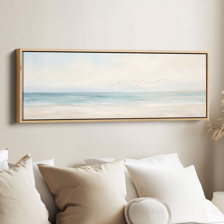 Panoramic Wall Art Calm Sea and Shoreline with Birds for Bedroom canvas in an oak frame, above the bed
