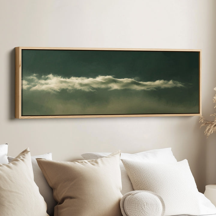 Living Room Wall Art Long Narrow Cloud Band on Dark Green Minimalist canvas in an oak frame, above the bed