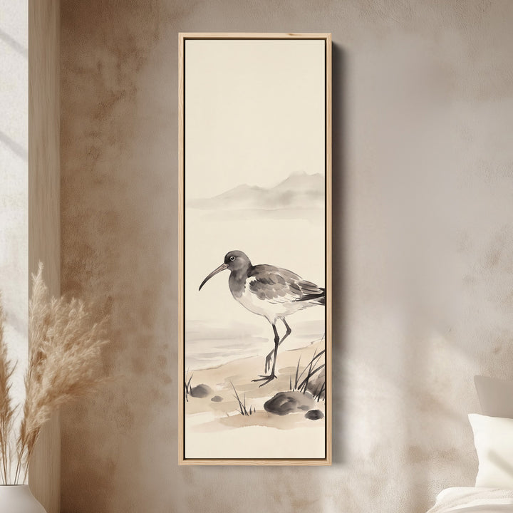 Quiet Coastal Curlew on the Shore Tall Narrow Wall Art for Bedroom canvas in an oak frame, above the bed in a modern bedroom