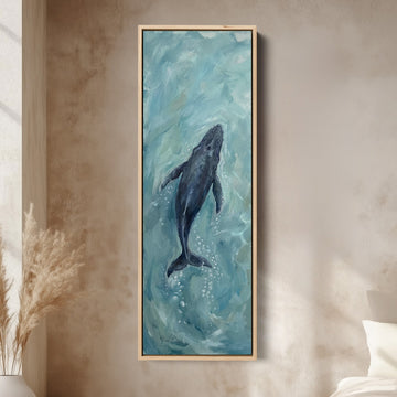 Deep Blue Ocean Diving Whale Long Narrow Wall Art for Bedroom canvas in an oak frame, above the bed in a modern bedroom