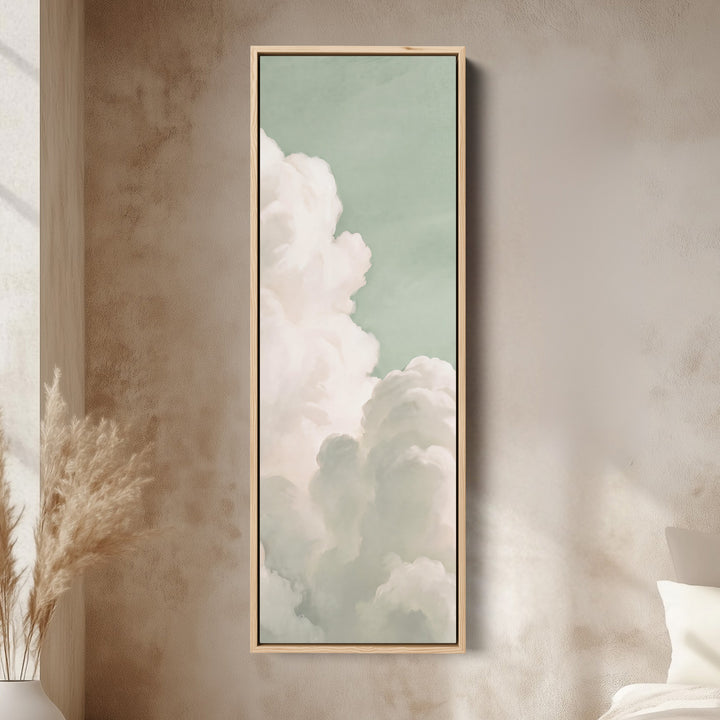 Bedroom Wall Art Vertical White Clouds on a Mint Sky canvas in an oak frame, above the bed in a modern bedroom