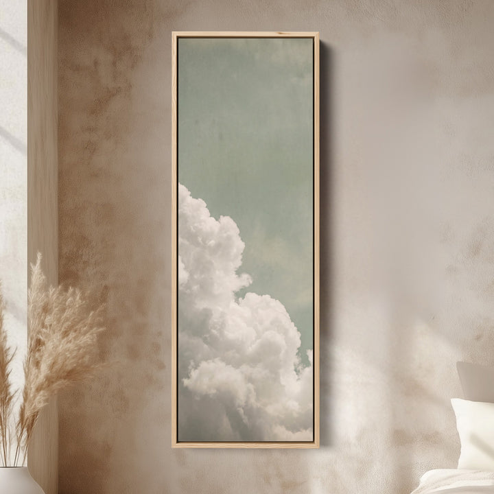 White Clouds on a Sage Sky Vertical Wall Art for Living Room canvas in an oak frame, above the bed in a modern bedroom