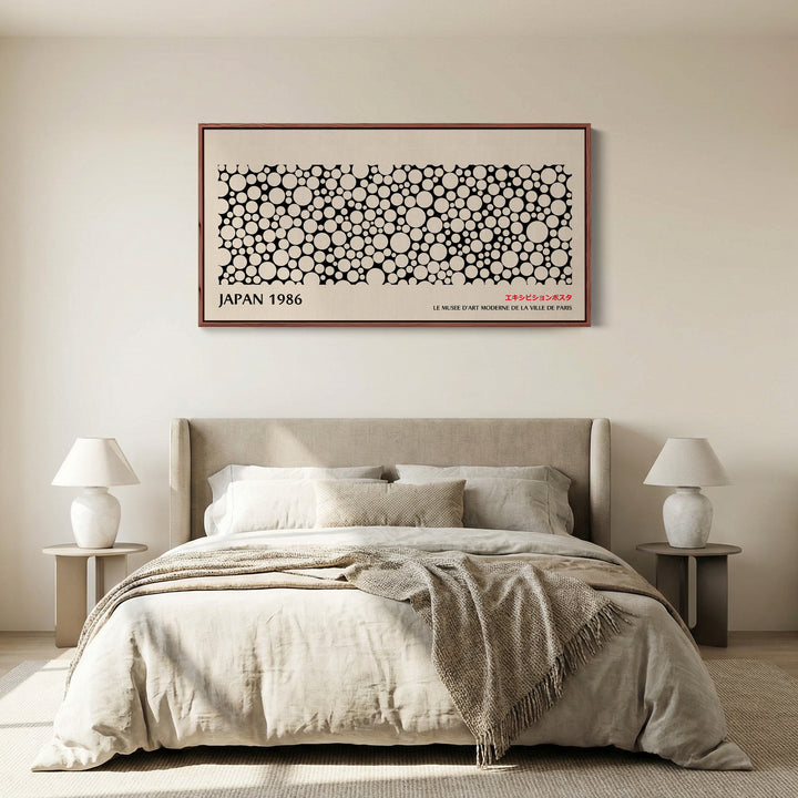 Japanese wall art black and white dot pattern horizontal canvas print in a walnut floating frame displayed in a living room