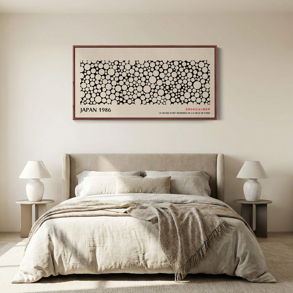 Japanese wall art black and white dot pattern horizontal canvas print in a walnut floating frame displayed in a living room