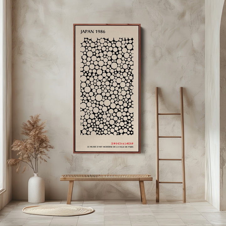 Japanese wall art polka dot pattern vertical tall canvas in a walnut floating frame displayed in a living room