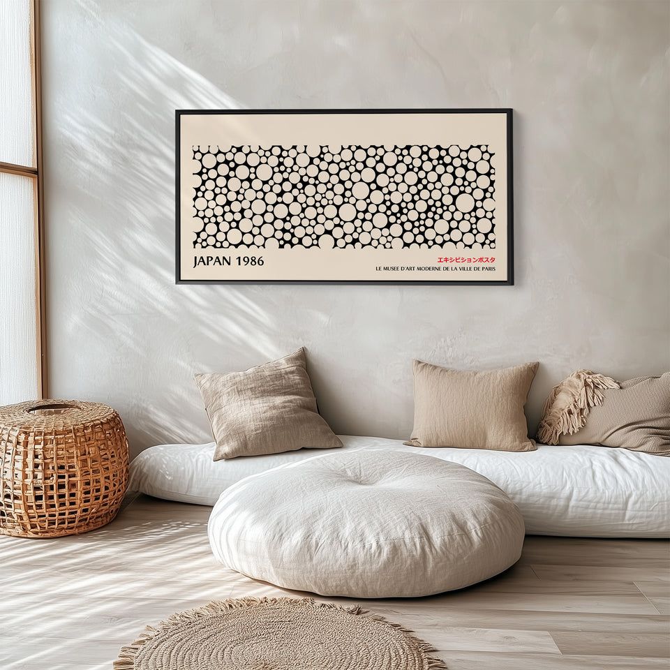 Japanese wall art black and white dot pattern horizontal canvas print in a black floating frame displayed in a living room