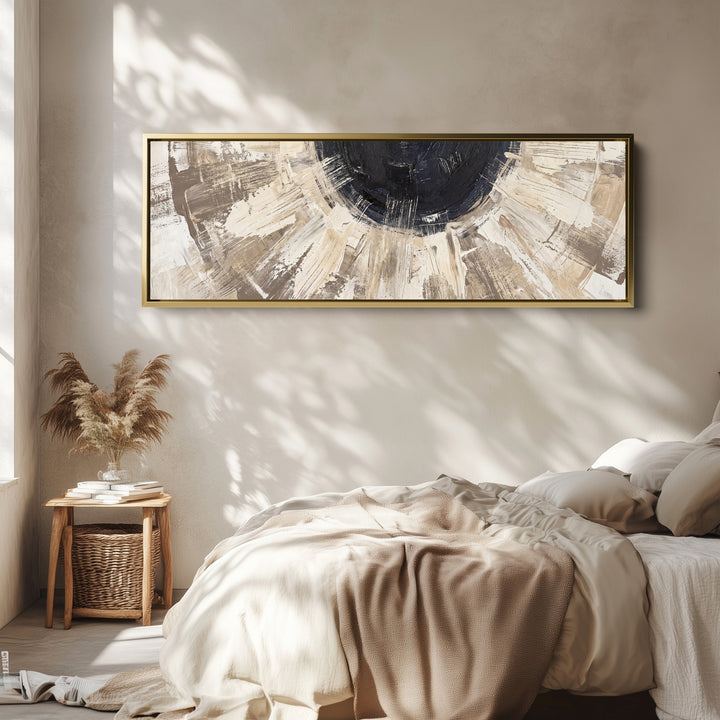 Above Bed Wall Art Panoramic Neutral Brushstroke Sunburst Abstract wall art in a gold frame, above the bed