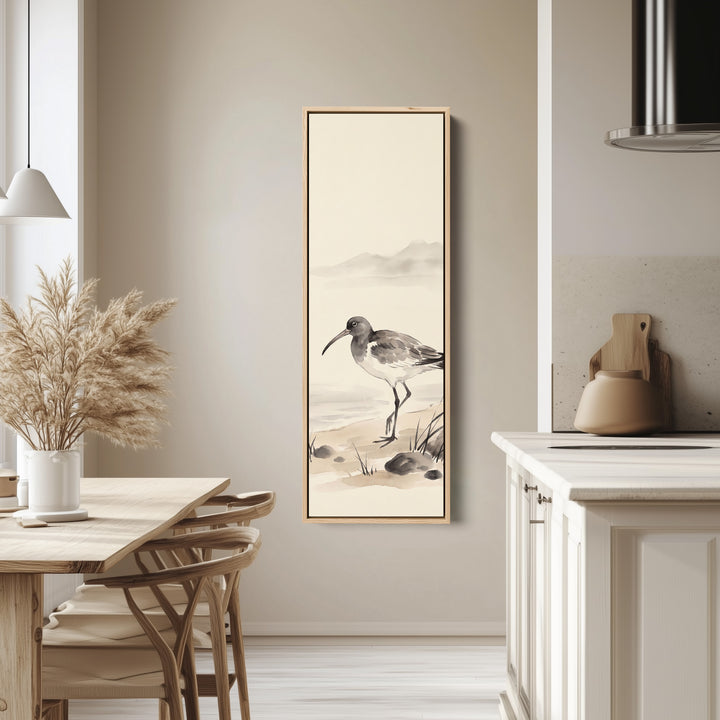 Quiet Coastal Curlew on the Shore Tall Narrow Wall Art for Bedroom tall canvas in an oak frame, hung in a bright kitchen