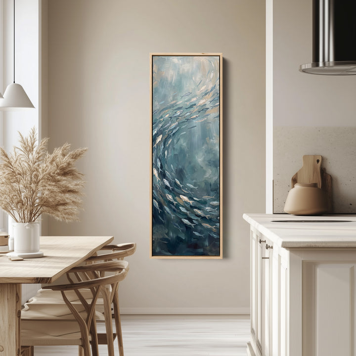 Vertical Wall Art Swirling Shoal of Fish Underwater for Hallway tall canvas in an oak frame, hung in a bright kitchen