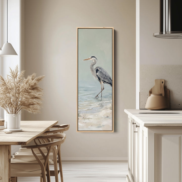 Grey Heron Wading Tall Wall Art Coastal Canvas for Living Room tall canvas in an oak frame, hung in a bright kitchen