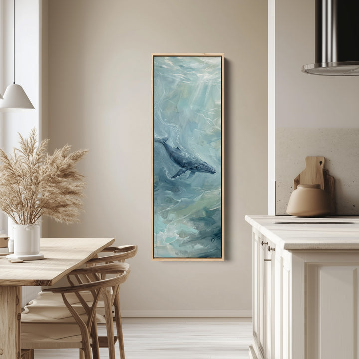 Office Wall Art Vertical Whale Swimming in Blue Green Water tall canvas in an oak frame, hung in a bright kitchen