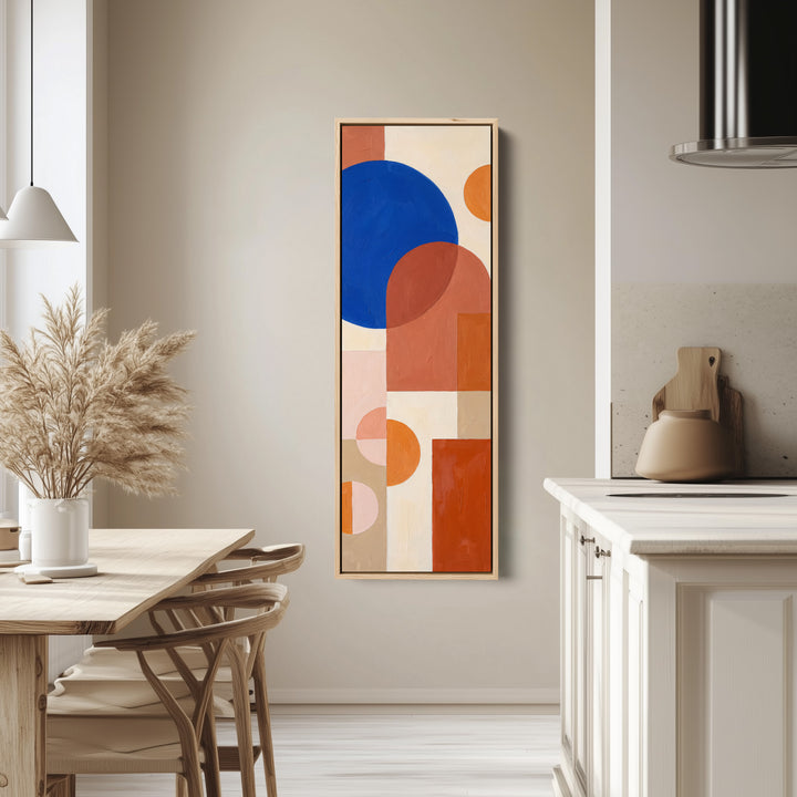 Kitchen Wall Art Tall Bauhaus Shapes in Cobalt and Orange tall canvas in an oak frame, hung in a bright kitchen