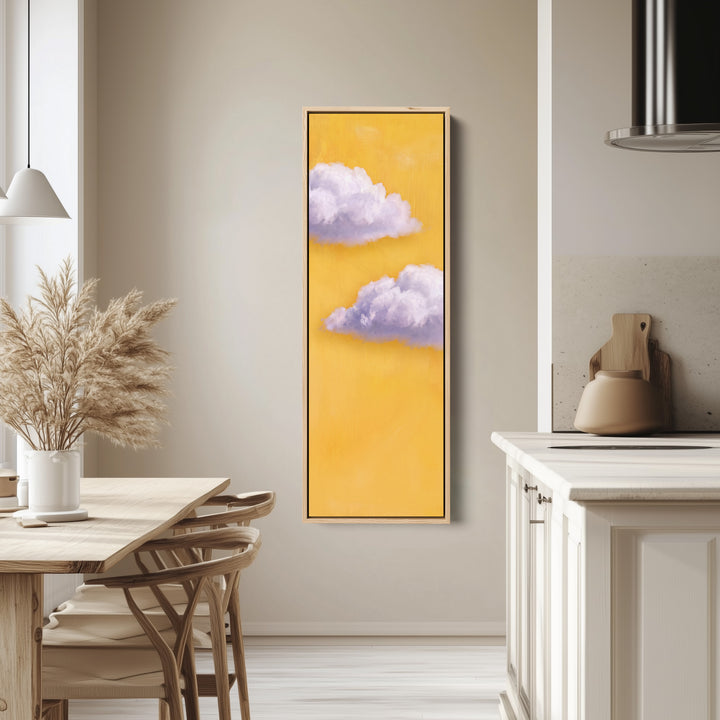 Vertical Wall Art Lilac Clouds on Yellow for Kids Room tall canvas in an oak frame, hung in a bright kitchen