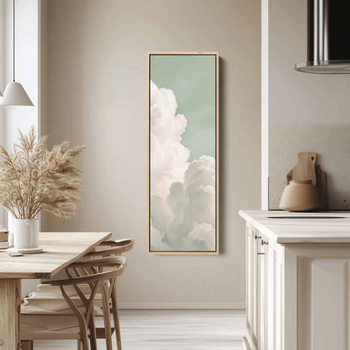 Bedroom Wall Art Vertical White Clouds on a Mint Sky tall canvas in an oak frame, hung in a bright kitchen