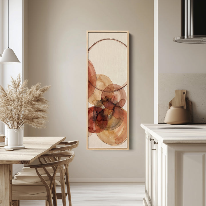 Warm Earthy Watercolor Circles Tall Narrow Wall Art for Living Room tall canvas in an oak frame, hung in a bright kitchen