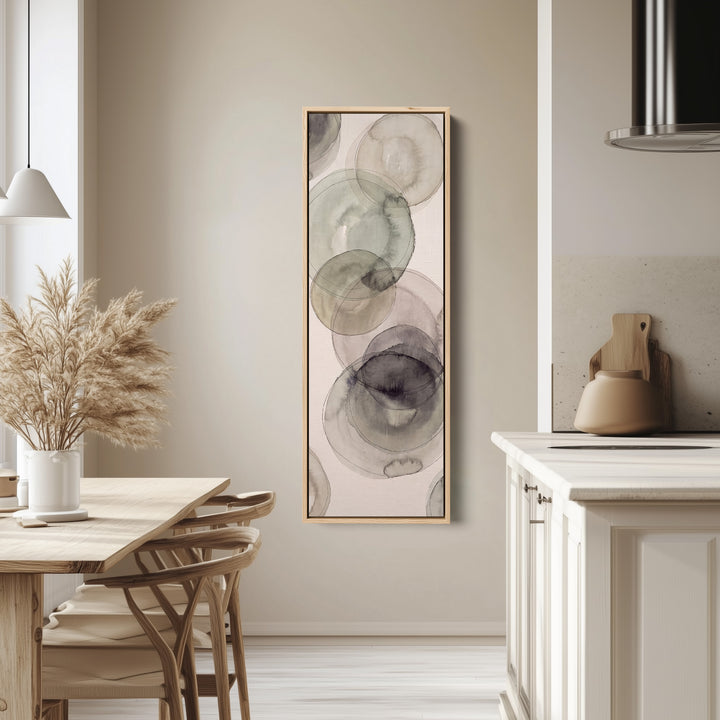 Office Wall Art Vertical Grey Watercolor Circles Abstract tall canvas in an oak frame, hung in a bright kitchen